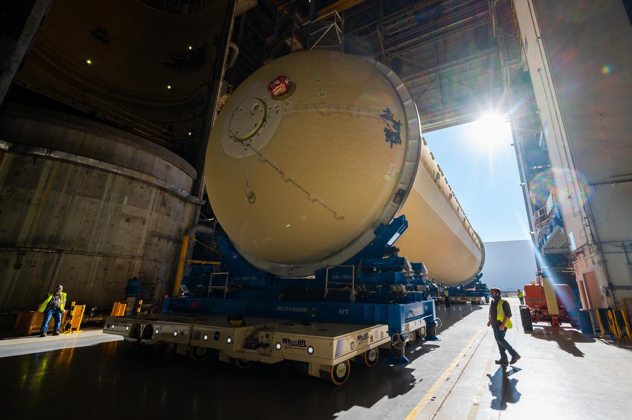 Technicians transported the assembled upper part of the Artemis II core stage to the final assembly area inside the factory at NASA’s Michoud Assembly Facility in New Orleans. On Jan 10, the forward assembly, left was moved next to the Artemis II liquid hydrogen tank, which has been undergoing assembly. Next, Boeing, the lead core stage contractor, will join the forward assembly and the liquid hydrogen tank to complete most of the core stage for the Space Launch System (SLS) rocket that will send the first crew on an Artemis mission. The core stage consists of five major structures that are built, outfitted, and then connected to form the final stage. The forward skirt, liquid oxygen and intertank were connected and tested to form the 66-foot forward assembly. After the forward assembly is joined with the 130-foot liquid hydrogen tank, only the engine section, the fifth piece of the stage, will need to be added to complete the Artemis II core stage. The core stage serves as the backbone of the rocket, supporting the weight of the payload, upper stage, and crew vehicle, as well as the thrust of its four RS-25 engines and two five-segment solid rocket boosters attached to the engine and intertank sections. On Artemis II, the SLS rocket will launch the Orion spacecraft and a crew, sending them into lunar orbit, in preparation for later Artemis missions that will enable the first woman and first person of color to land on the Moon.